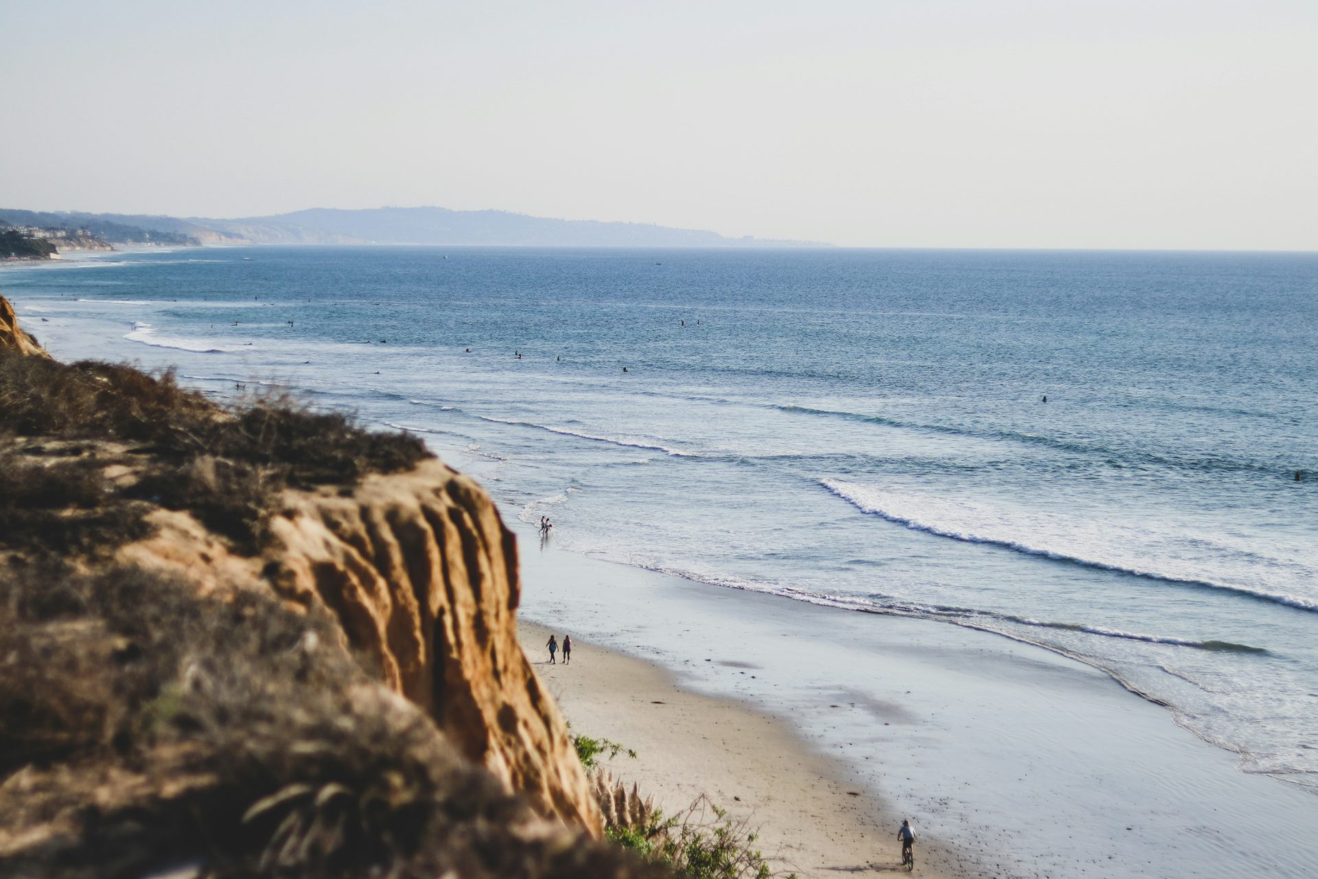 Looking south along the Encinitas coastline from the bluff, surfers dotting the water below