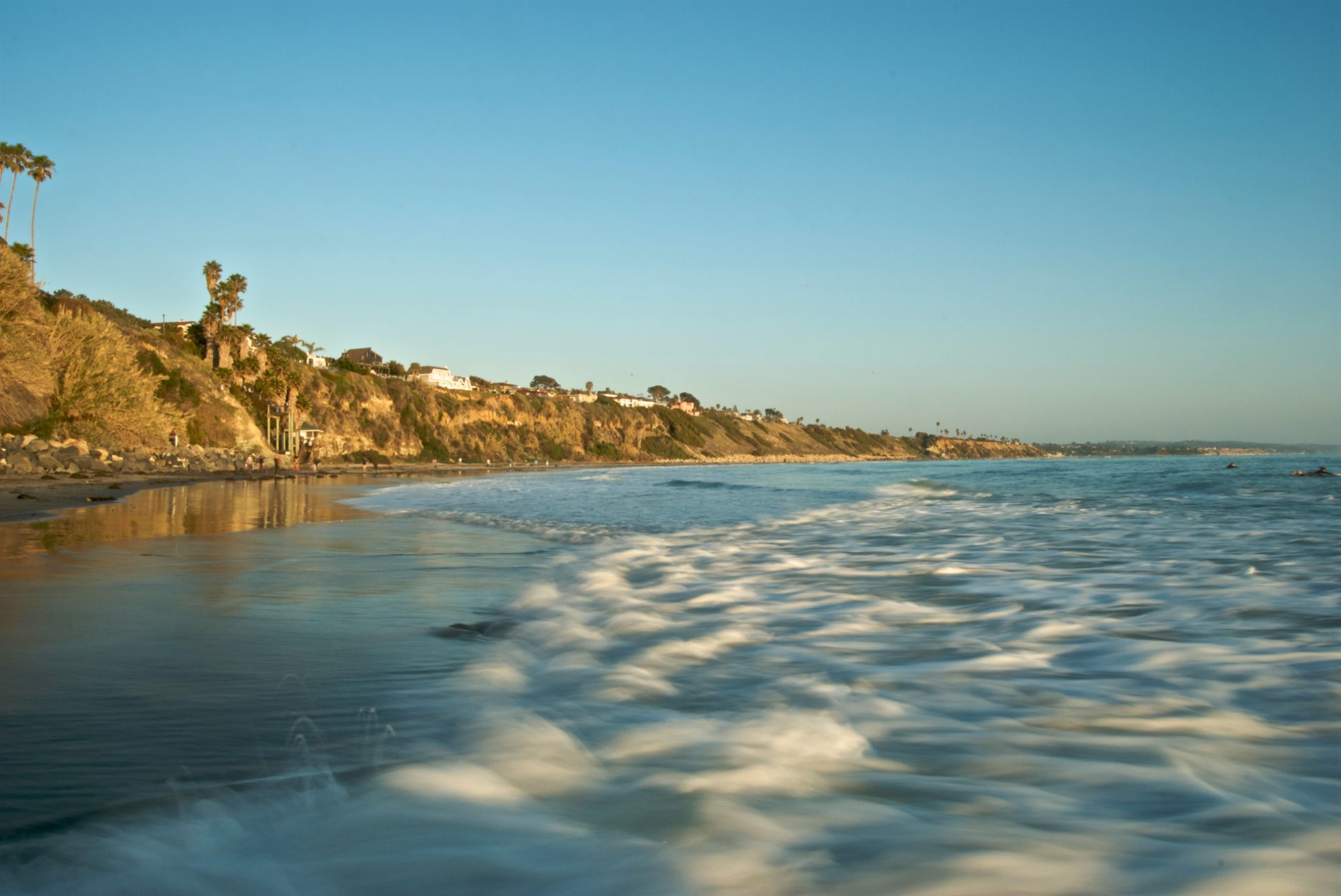 Golden-hour light on the bluffs at Swami's Beach in Encinitas, waves washing in